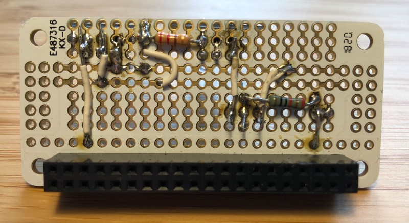 Bottom of prototyping board with solder and wire connections to components and GPIO pins